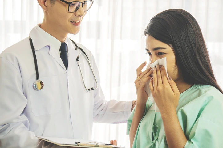 a woman getting a doctor consultation about cold