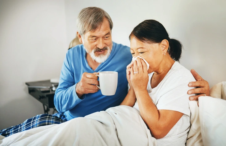 cold symtoms on a woman in bed