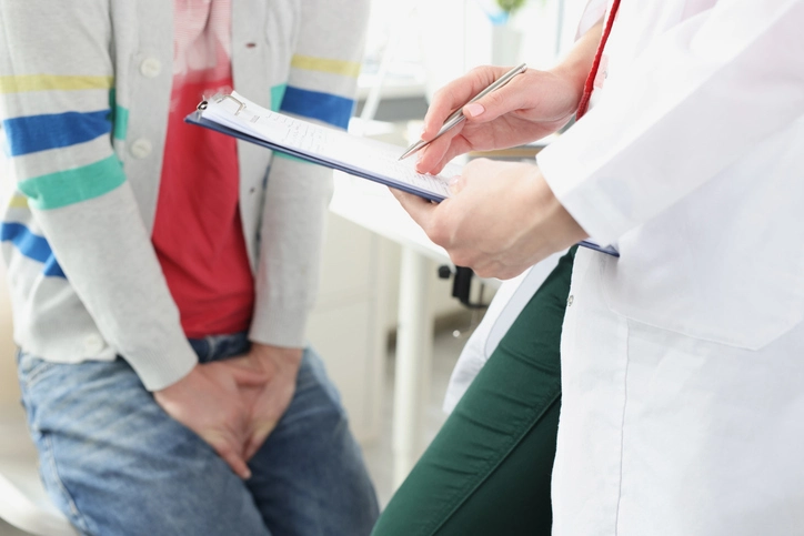 a man talking to a doctor about his UTI