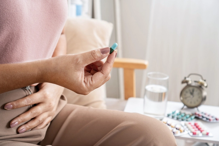 woman treating a UTI at home