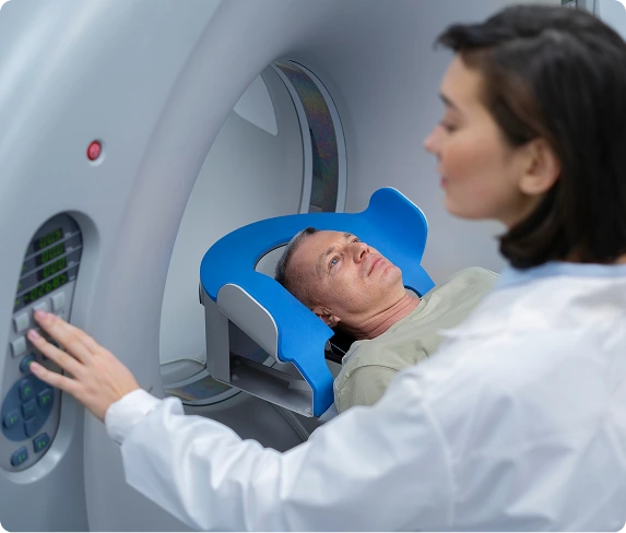 Austin Emergency Center — patient in CT/MRI scanner with technician adjusting machine
