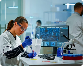 A woman in a lab coat works on a computer at Austin Emergency Center.