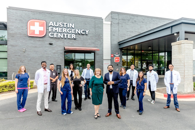 Medical Team standing in front of Austin Emergency Center building under overcast sky.
