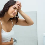 Person experiencing stomach pain from stress-induced diarrhea