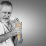 Man with wrist pain representing common joint pain signs.