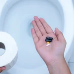 Pills in hand highlighting antibiotics causing diarrhea.